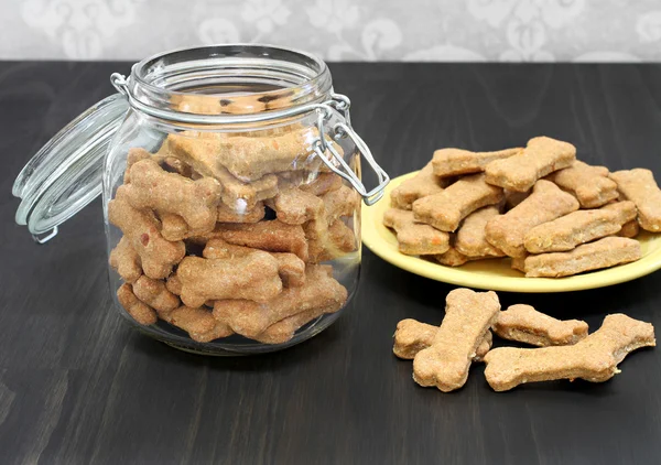Dog bones in a canister and on a wooden counter.  Healthy homead