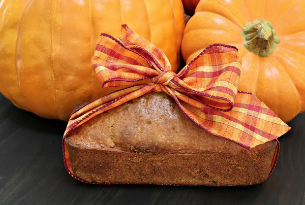 Pound cake wrapped in a fall ribbon with pumpkins.