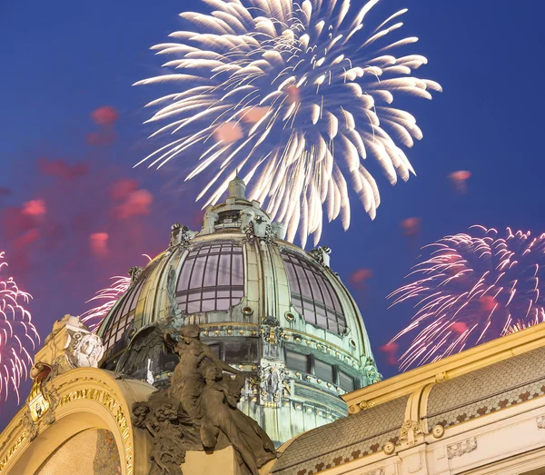 View on Municipal House (1912) in art nouveau style and holiday fireworks -- is a major landmark and concert hall in Prague, Czech Republic