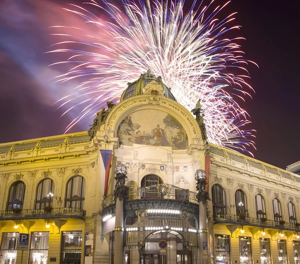 View on Municipal House (1912) in art nouveau style and holiday fireworks -- is a major landmark and concert hall in Prague, Czech Republic