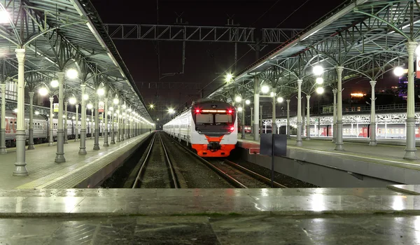 Train on Moscow passenger platform at night (Belorussky railway station) is one of the nine main railway stations in Moscow, Russia.