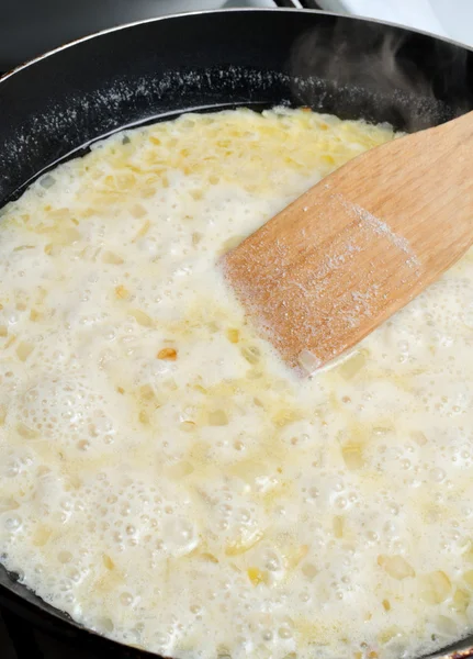 Cream added to the pan to cook the sauce