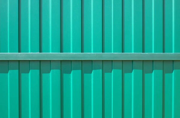 Green metal vertical fence as background