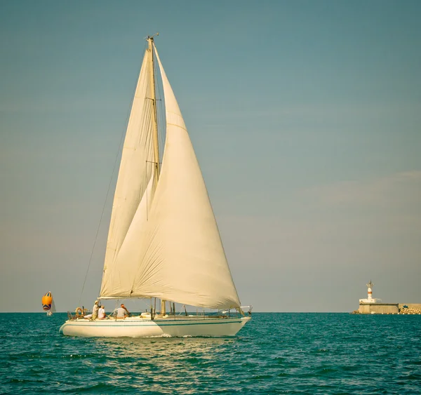 White sail yacht at the sea.