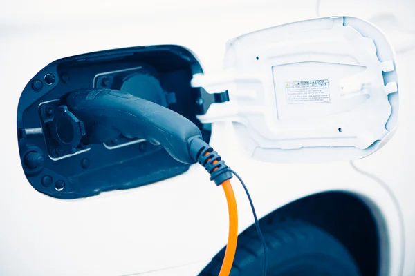 An electric car charging with power plug