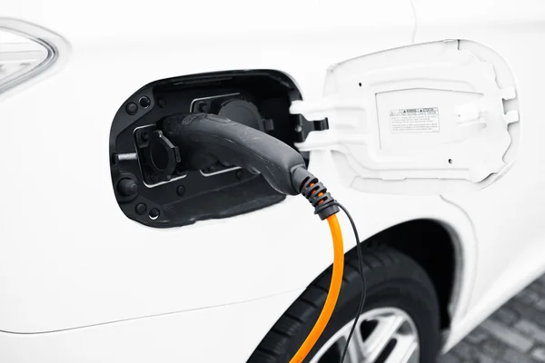 An electric car charging with power plug