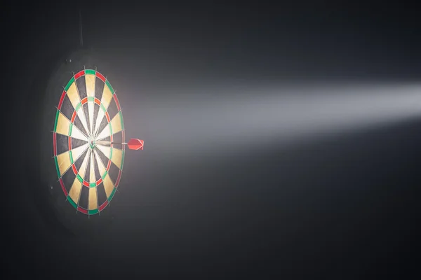 Darts board illuminated with a spotlight