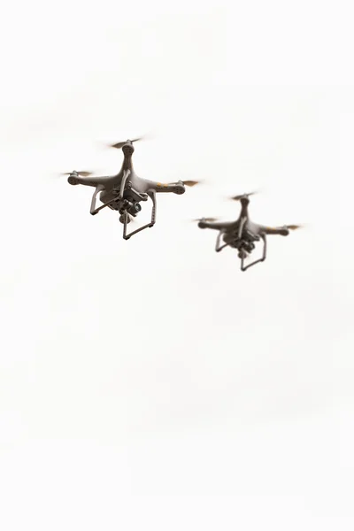 Flying drones with camera, quadcopters on white background