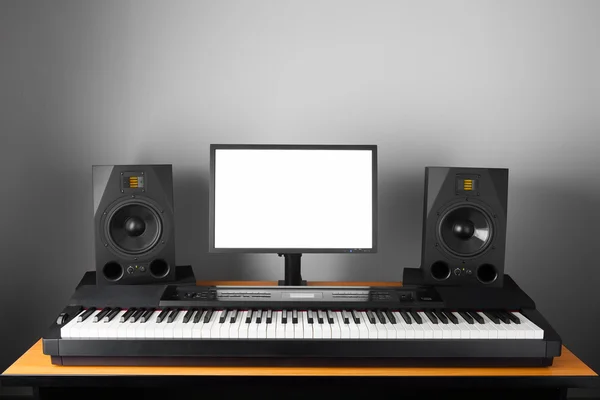 Digital audio workstation (daw) studio with electronic piano and monitor speakers