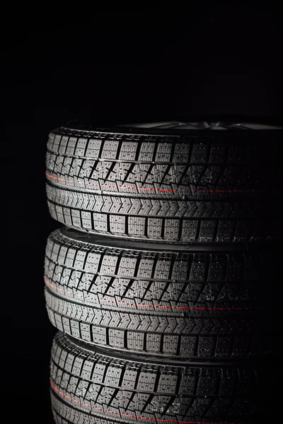 Studless winter tires stack, black background