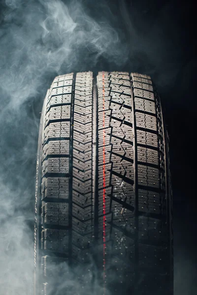 Winter tire in smoke