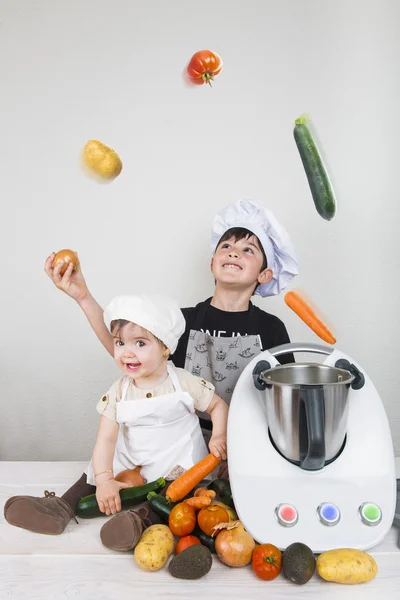 Two children cooking with a futuristic machine