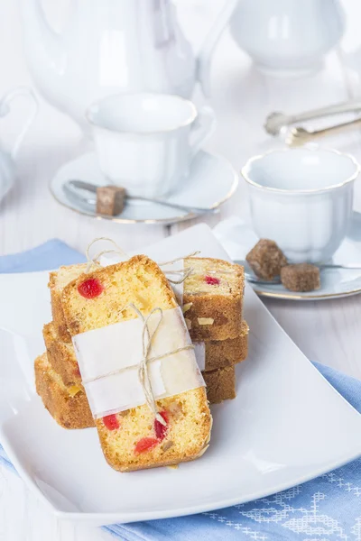 Candied fruits cake with tea and coffee for breakfast