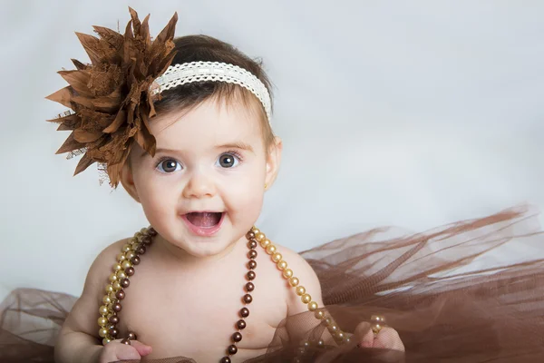 Smiling baby ballerina in brown tutu