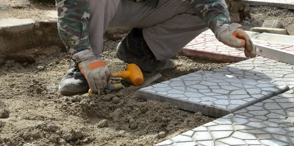 Workers paving  walkway Men at work concept