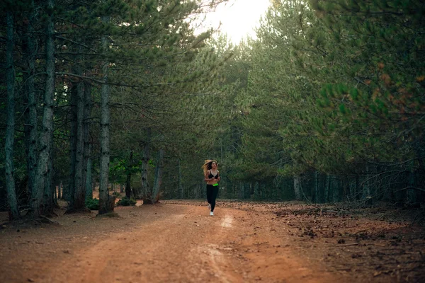 Young sexy blonde girl running in nature