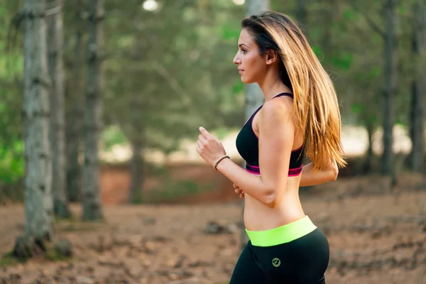 young sexy blonde girl running in nature