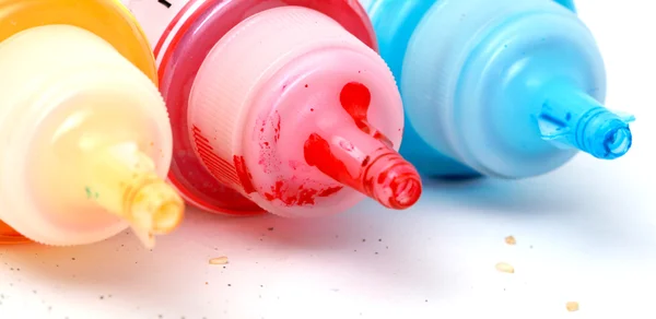 Bottles of ink printer cartridges on white background.