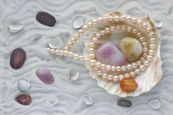 Pearls on white sea sand concept