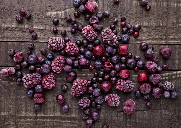 Frozen berries mix on wooden background