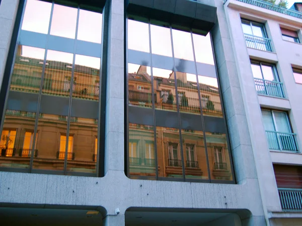 Street view with reflections in a building's window