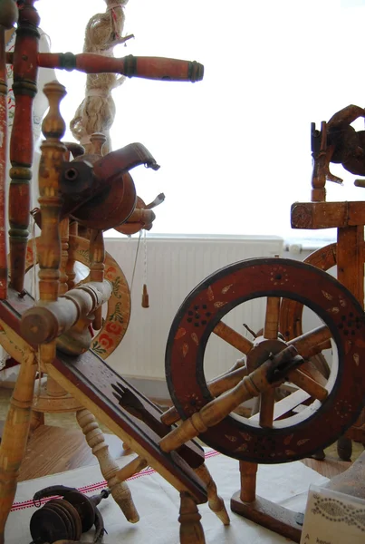 antique wooden spinning wheel with yarn and bobbins