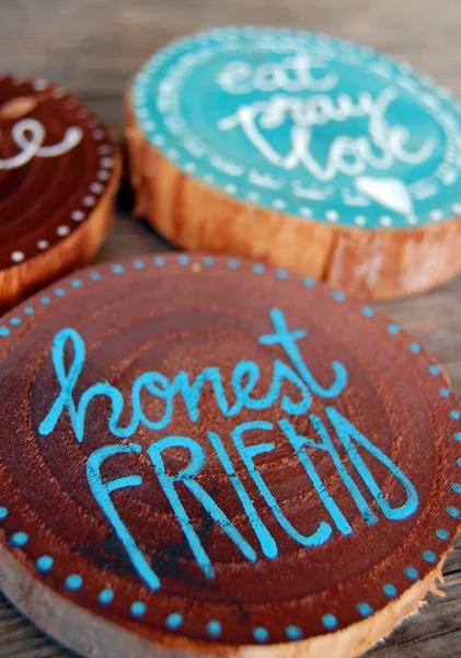 Closeup of Badges with words, honest friend, eat pray love