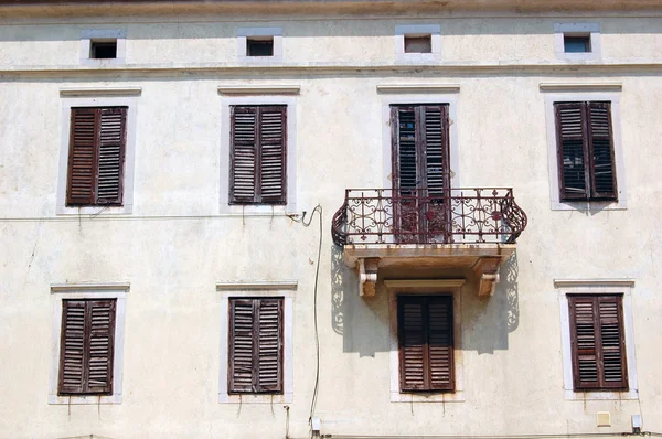 Detail of old building\'s facade with windows