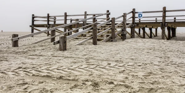 Wooden platforms on the North Sea beach