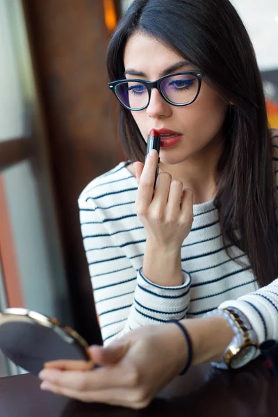 Young beautiful woman making up her face.