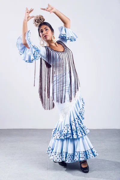 Pretty young flamenco dancer in beautiful dress.