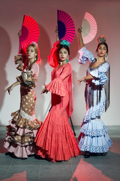 Pretty three young flamenco dancer in beautiful dress.