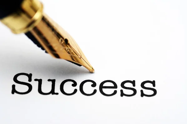 Fountain pen on success text