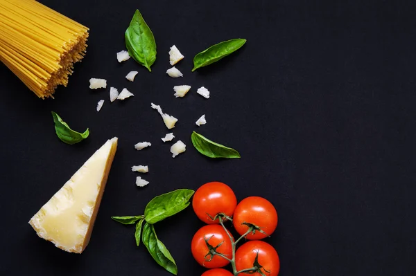 Food frame. Pasta ingredients. Cherry-tomatoes, spaghetti pasta,