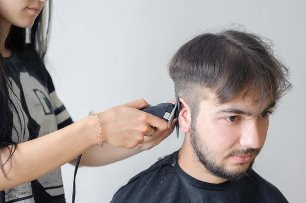 Men\'s hairstyling and haircutting in a barber shop or hair salon