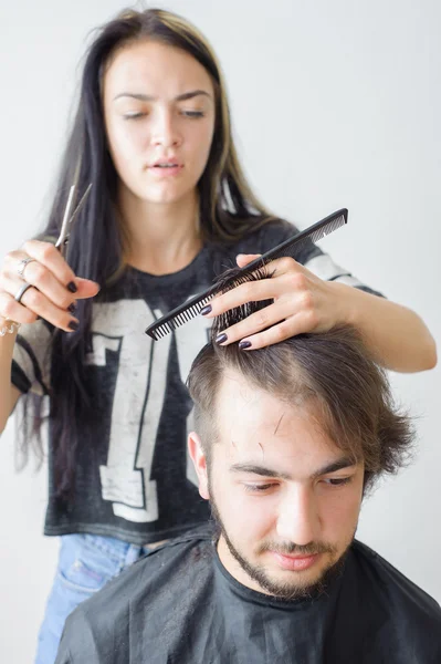 Men\'s hairstyling and haircutting in a barber shop or hair salon