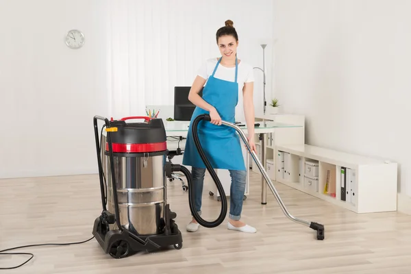 Female Janitor With Vacuum Cleaner