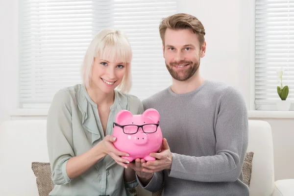 Couple Holding Piggybank