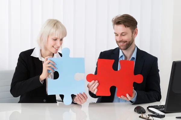Businesspeople Holding Puzzle Pieces