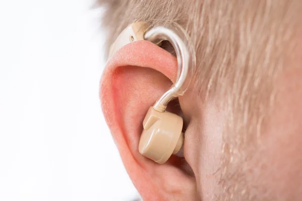 Man With Hearing Aid Behind Ear