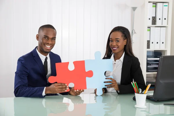 Happy Businesspeople Holding Puzzle
