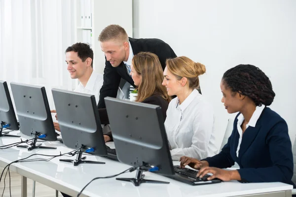 Businessman Helping His Colleagues In The Office