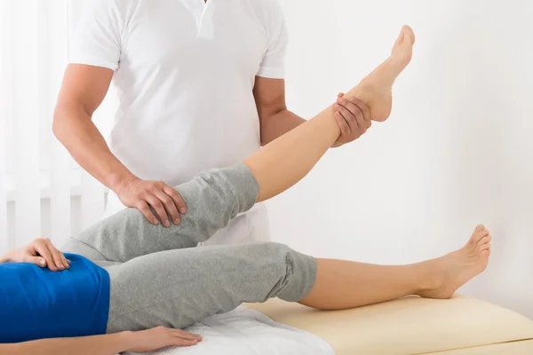 Woman Receiving Leg Massage In Spa
