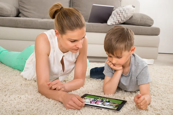 Mother And Son Watching Movie On Digital Tablet