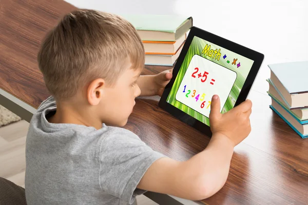 Pupil Solving Math Problem On Digital Tablet