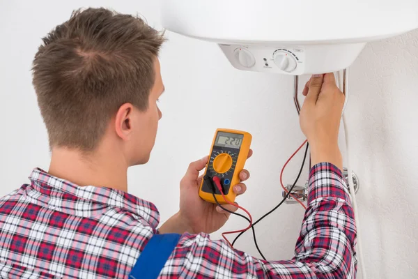 Plumber Checking Electric Boiler