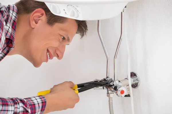 Worker Repairing Electric Boiler With Wrench