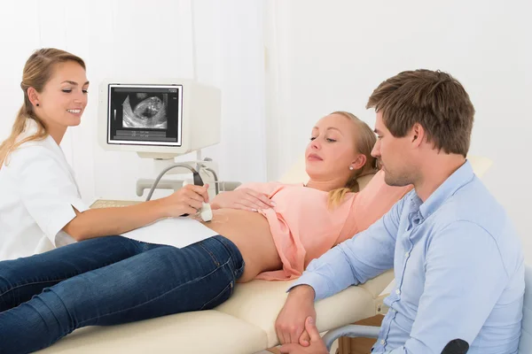 Doctor Moving Ultrasound Transducer On Pregnant Woman\'s Belly