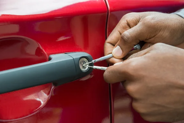 Hands Opening Car Door With Lockpicker