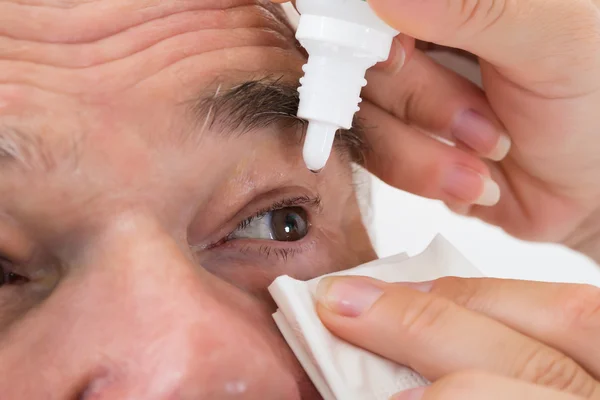 Optometrist Putting Eye Drops In Patient's Eye